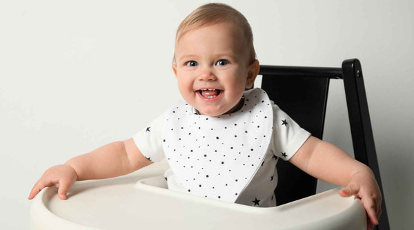 Baby wearing polka dots bib