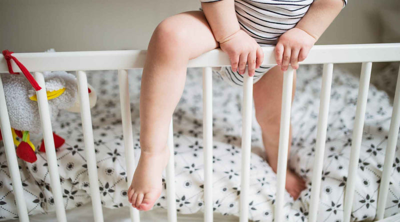 Baby climbing out of crib