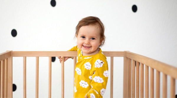 smiling baby in crib